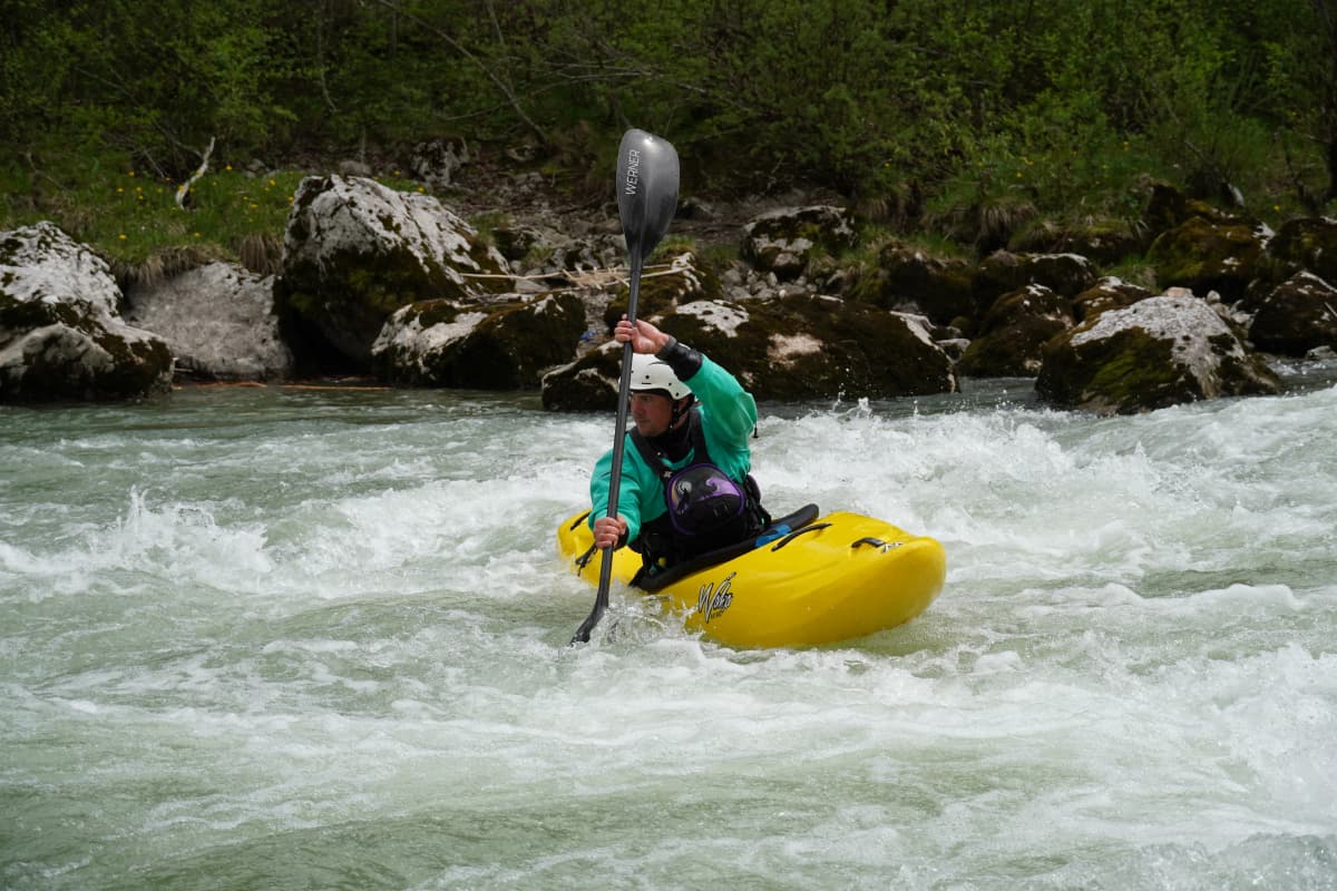 FlowSt8 coach navigating whitewater rapids during a coaching session